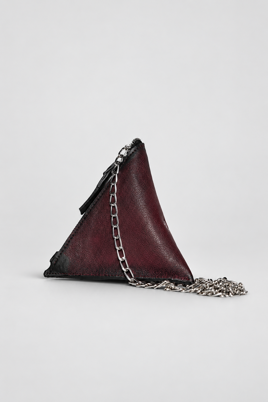 NUTSA NM9901 Leather Charm Pouch in burgundy black calf leather with triangular shape, detachable metal chain, and zipper closure
