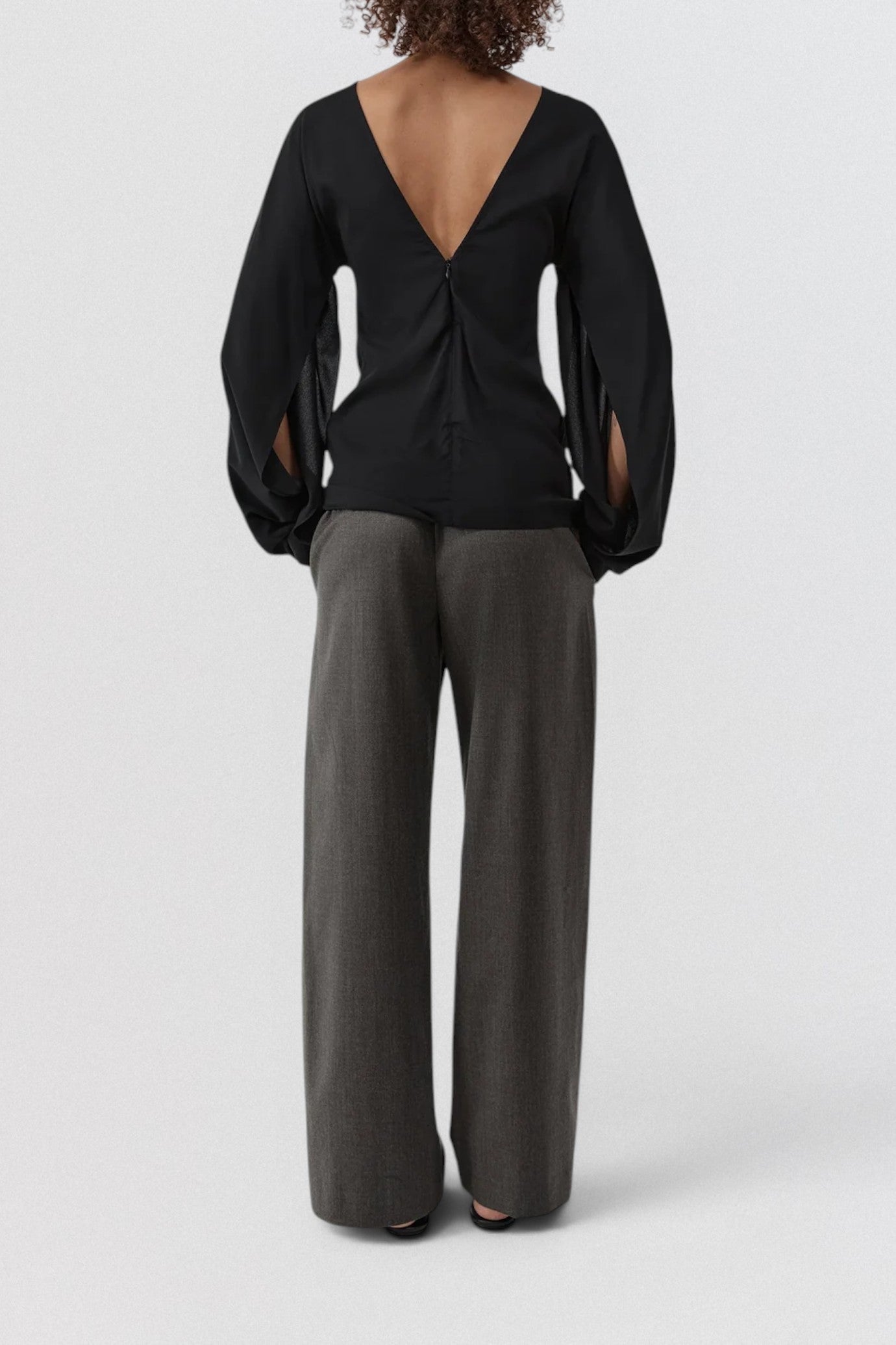 ST. AGNI Hybrid Top in black with multi-wear extended sleeves and fluid viscose construction
