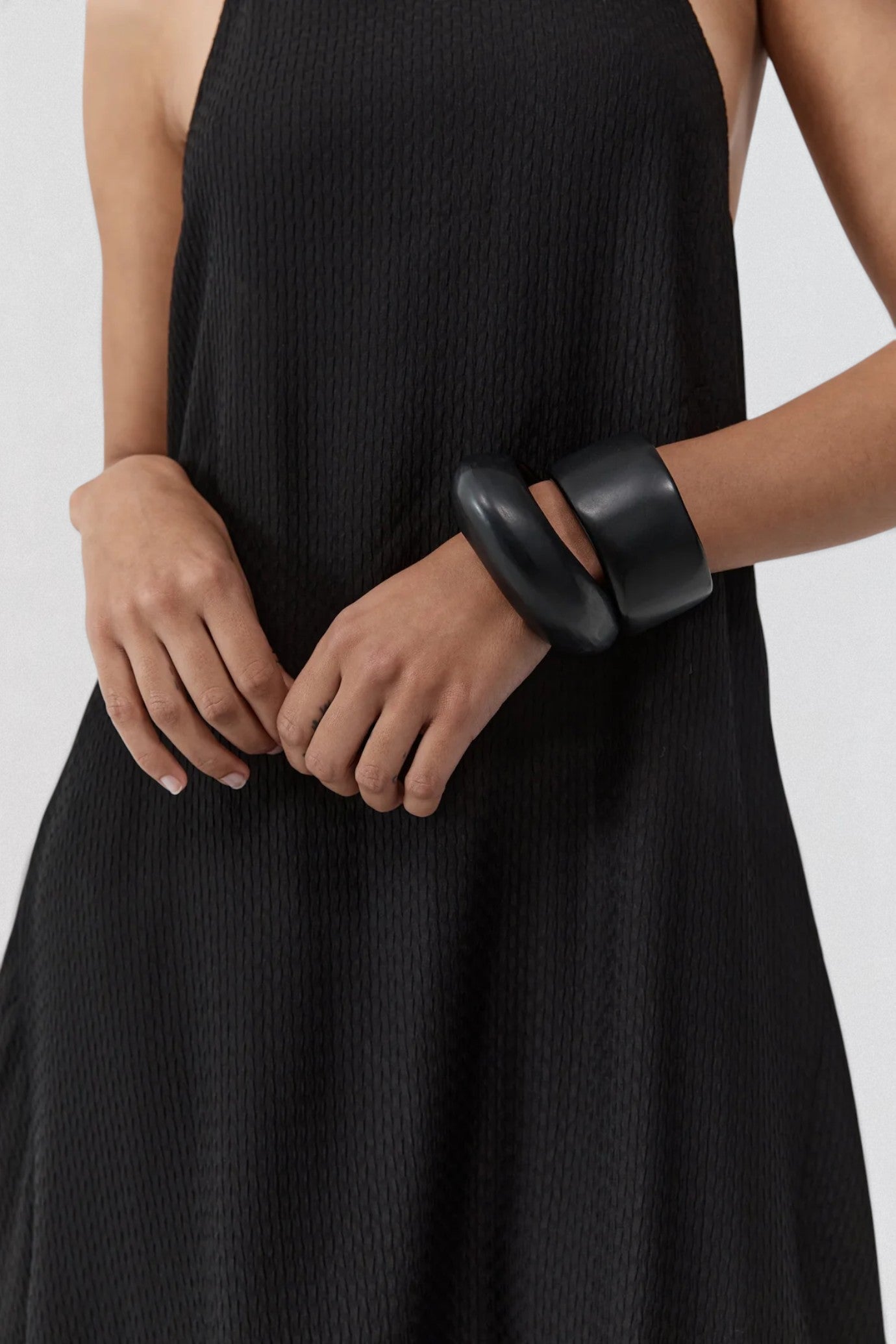 ST. AGNI Textured Weave Halter Dress in black with square halter neckline and asymmetric handkerchief hem