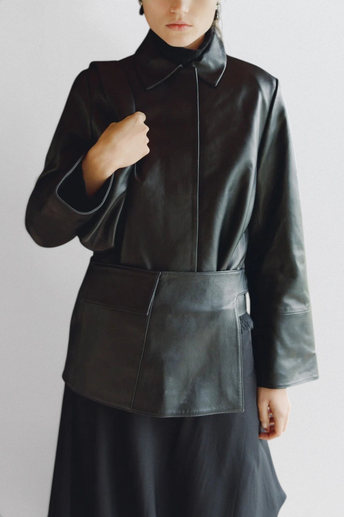 ST. AGNI Utility Skirt Belt in black lambskin leather with fold-over waistband and side cut-out detail