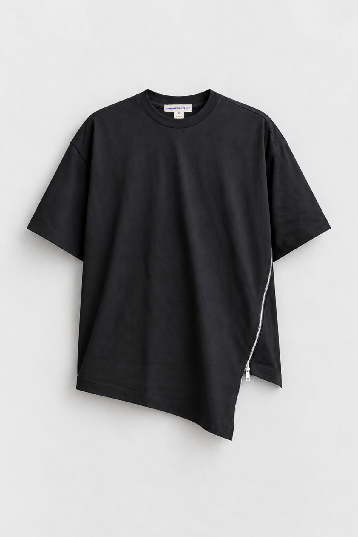 Comme des Garçons Shirt Black Zip Tee in black cotton with short sleeves, asymmetric hem, and curved side zip detail