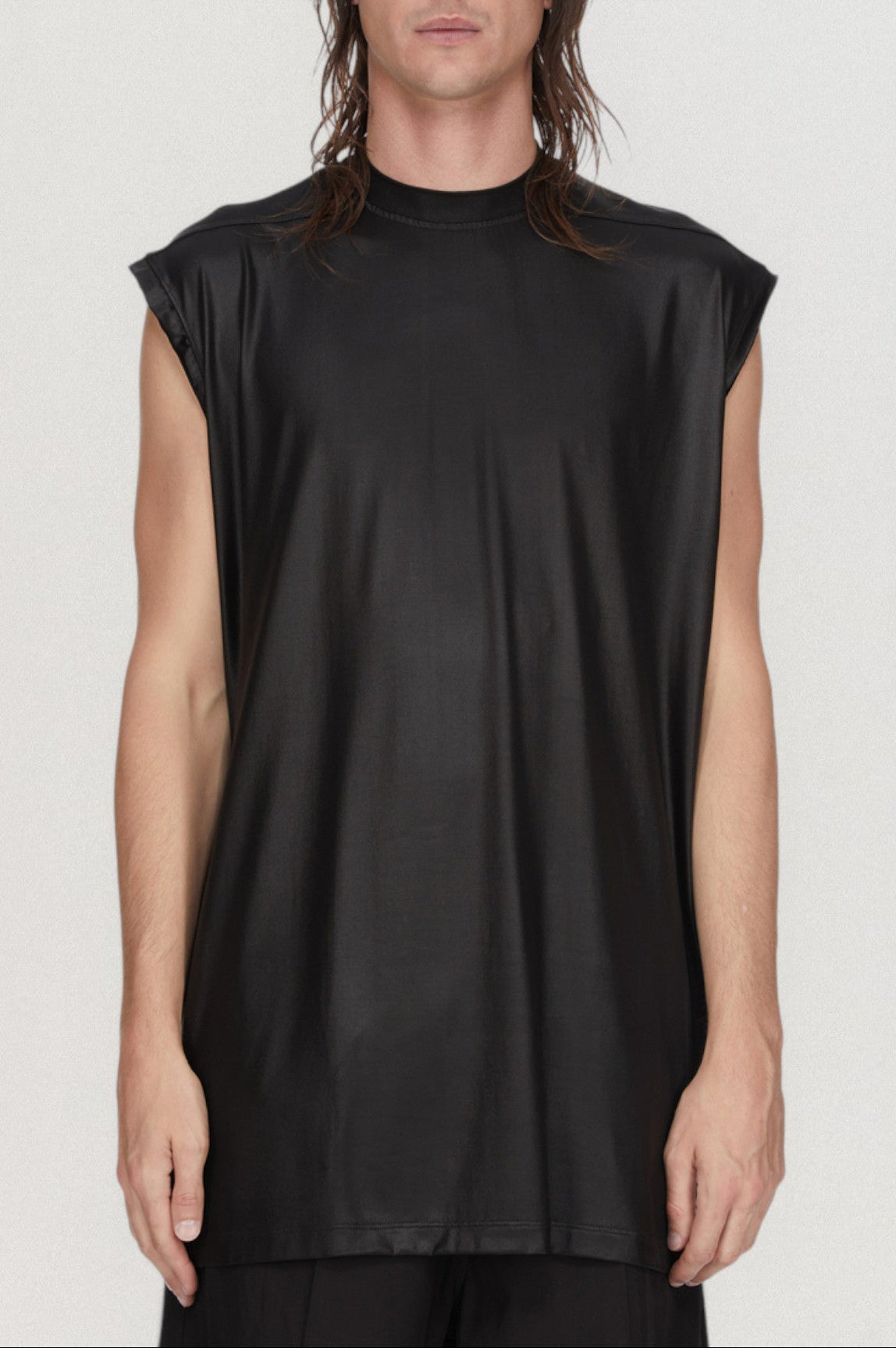 Person wearing a black sleeveless top on a white background