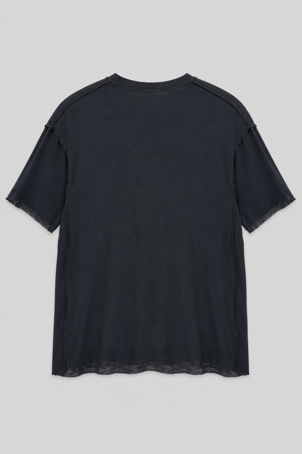Desu Reversible T Shirt in black with exposed seam construction, crew neckline, and raw hem detail.