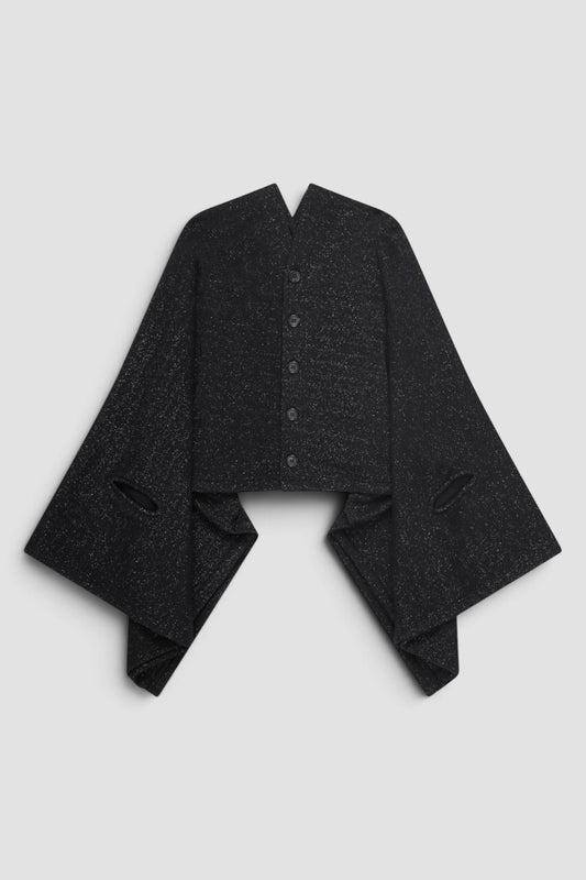 Junya Watanabe Glitter Cape Cardigan in Black with draped cape silhouette, cut out armholes, front button closure, and glitter fabric