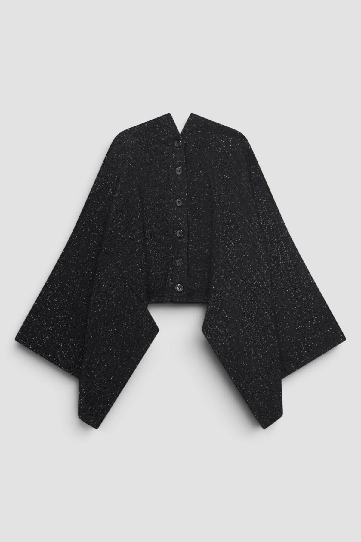 Junya Watanabe Glitter Cape Cardigan in Black with draped cape silhouette, cut out armholes, front button closure, and glitter fabric