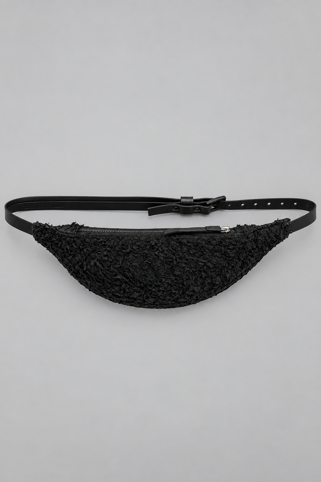 NUTSA NM1101B Belt Bag in black barracuda leather with curved pouch body, zipper closure, and adjustable leather strap