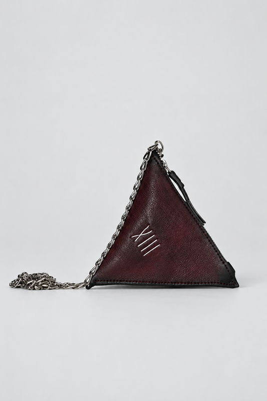 NUTSA NM9901 Leather Charm Pouch in burgundy black calf leather with triangular shape, detachable metal chain, and zipper closure