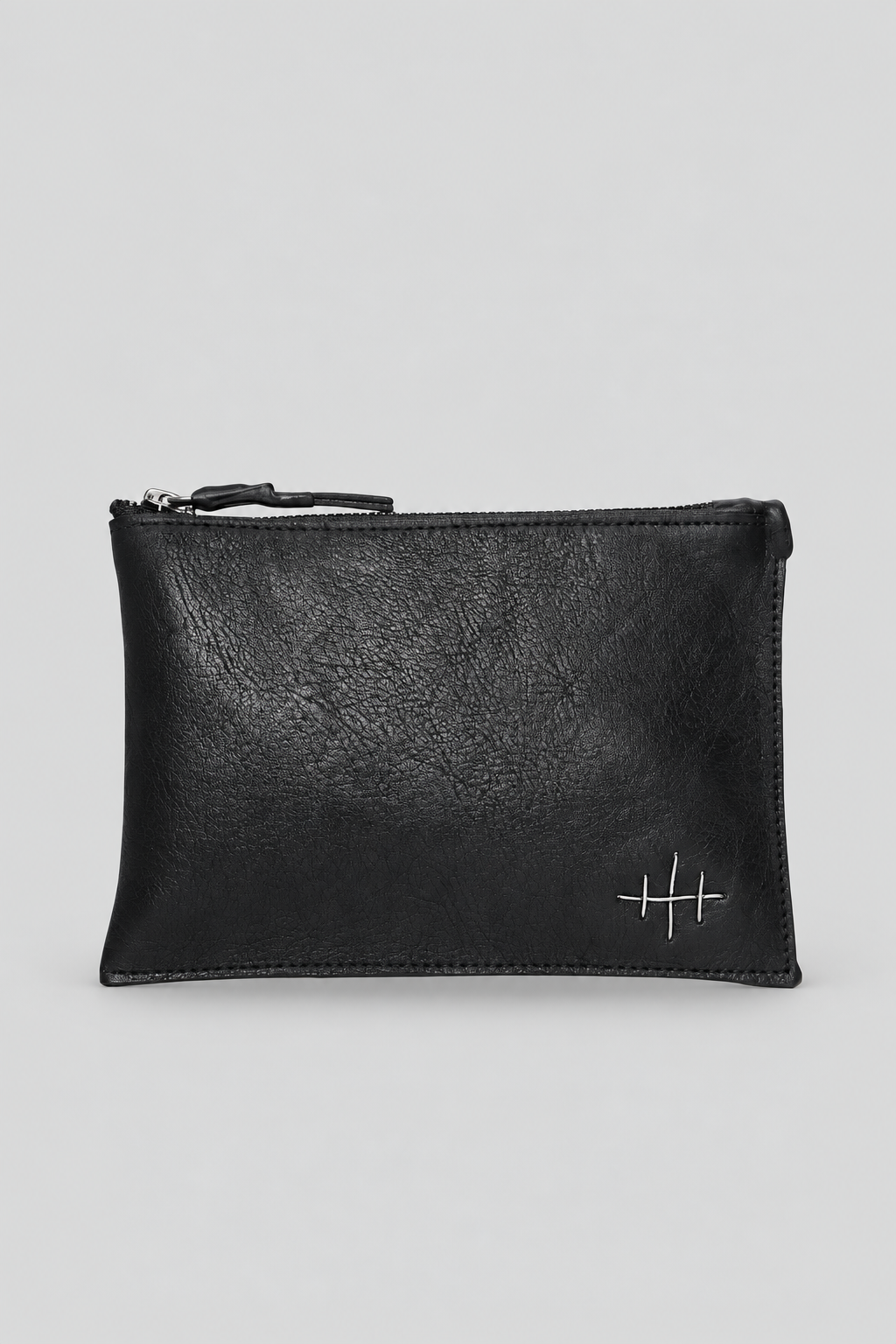 NUTSA NM9903 Leather Pouch in black calf leather with YKK zipper closure, fixed leather handle, and hand finished metal hardware