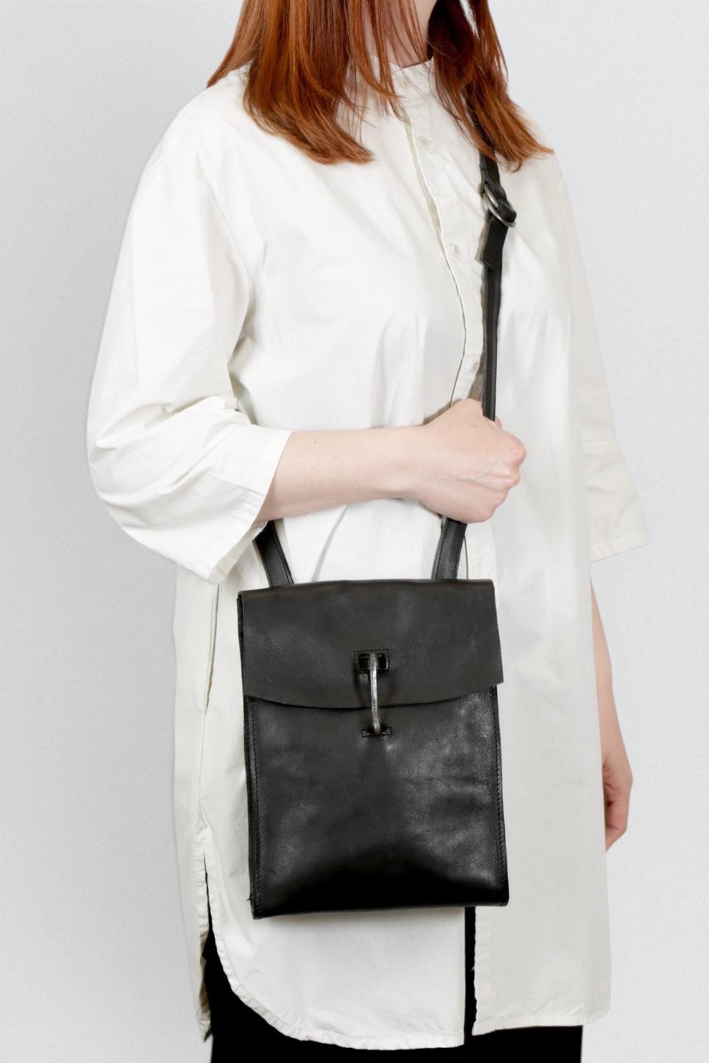 Tagliovivo Doctor Crossbody Bag worn on a model with white shirt and white background