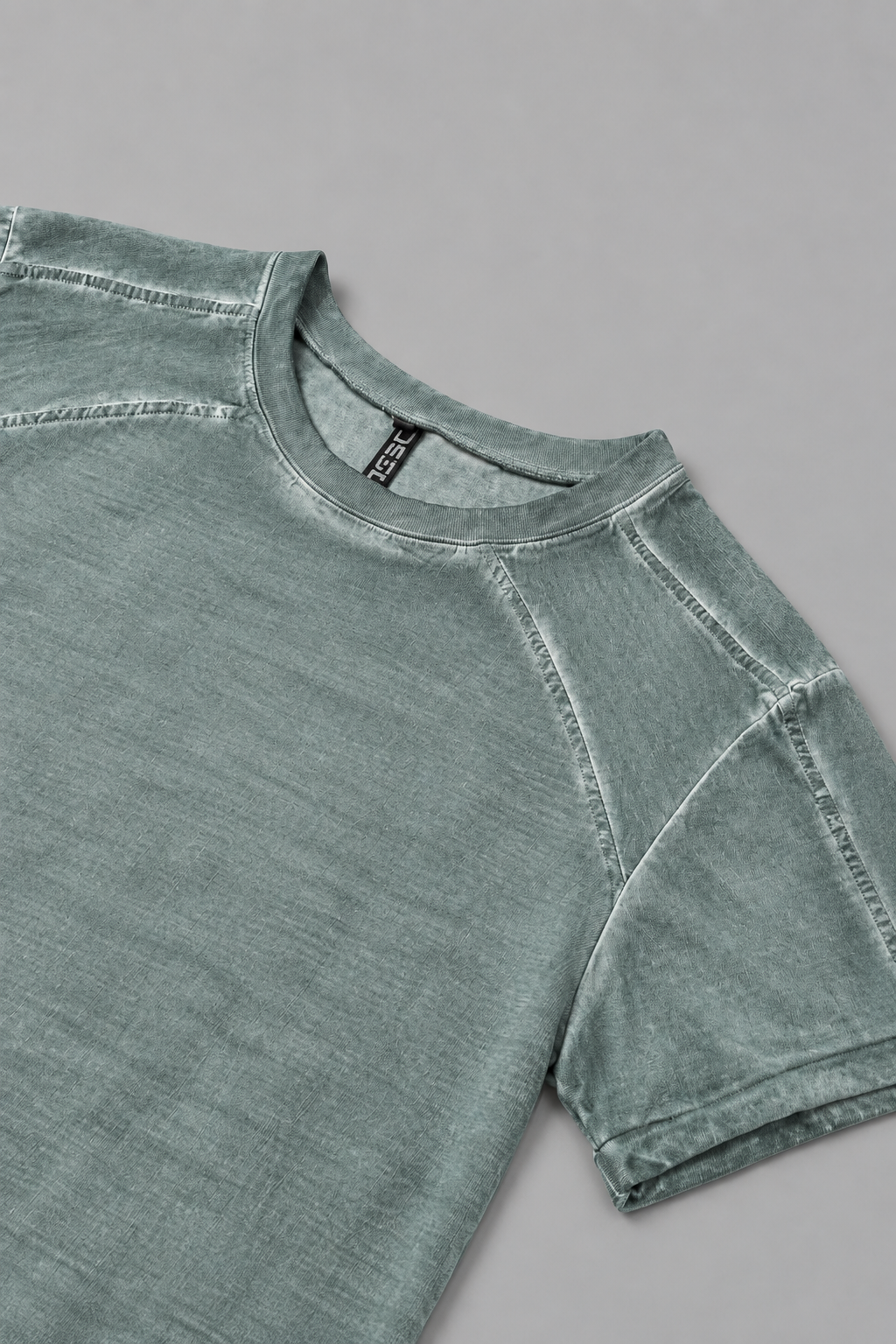 Shop the DESU Tony T Shirt in Dirty Turquoise at LABOUTIK Bali. A Supima cotton t shirt with relaxed fit, low cut shoulders, roll up sleeves, and pigment based cold dye finish.