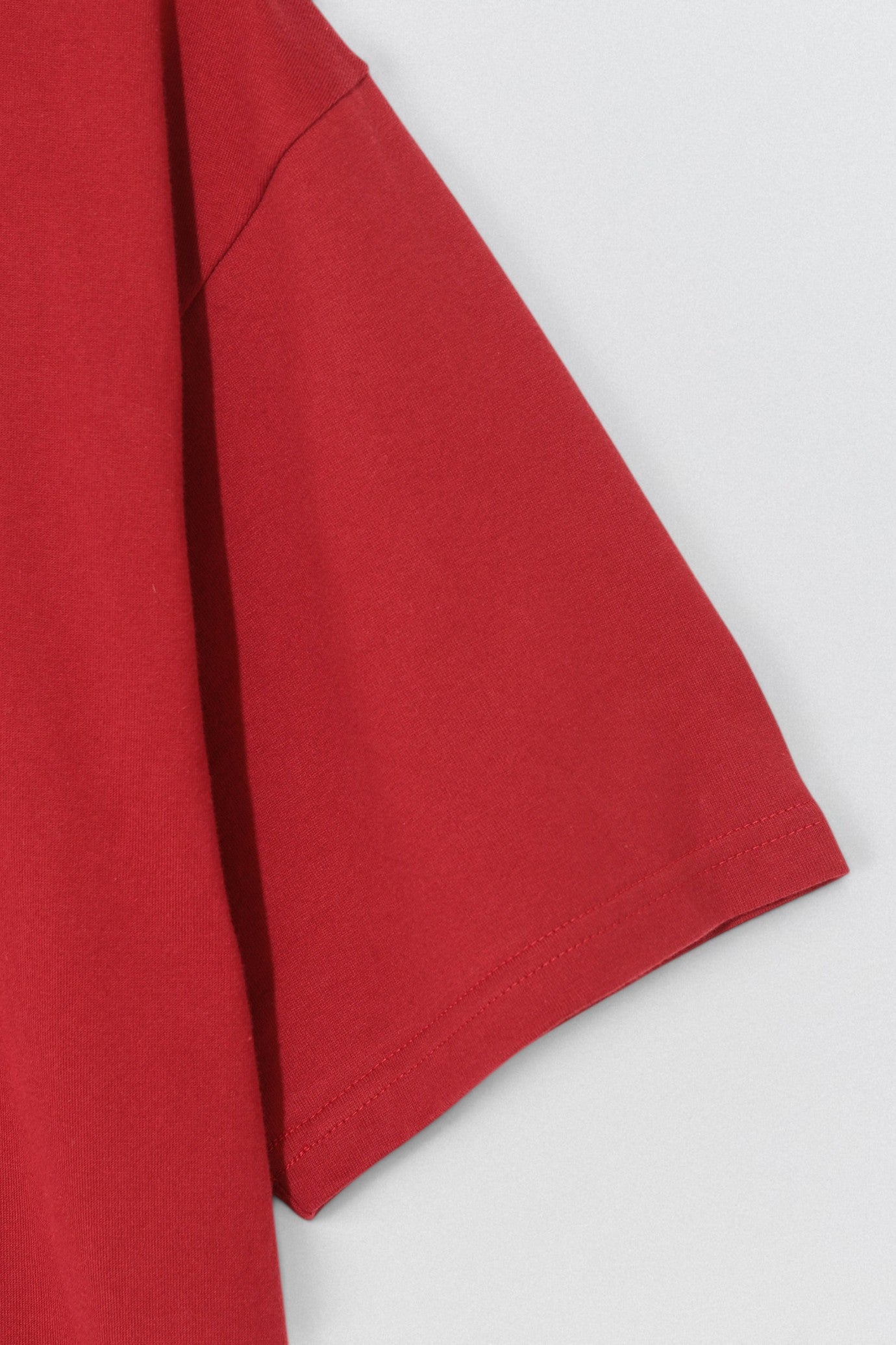 Undercover SS26 Bike Man T-Shirt  Red fabric on a white background