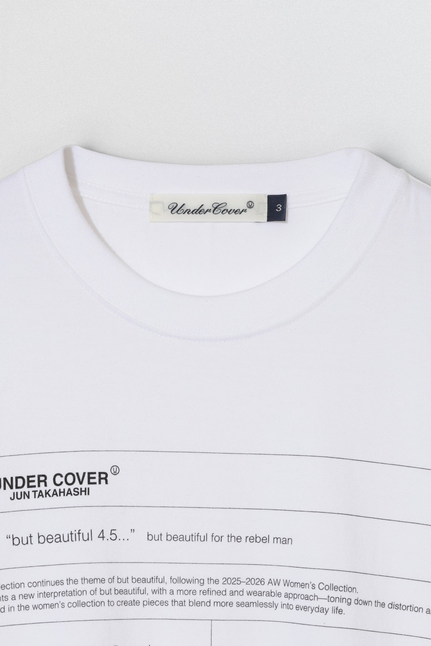 Undercover SS26 But Beautiful 4.5 White t-shirt with 'Undercover' label and text on a white background