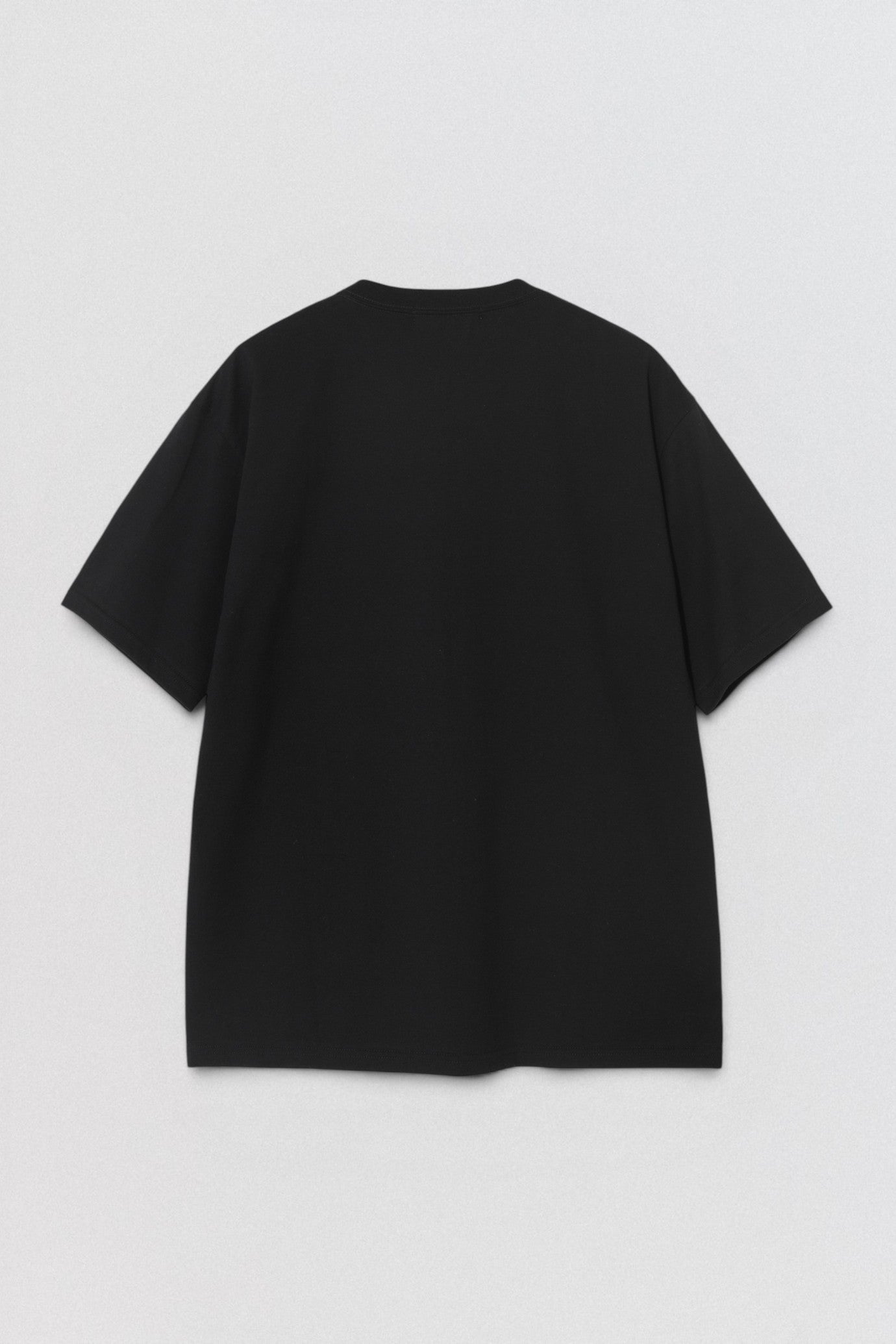 Undercover SS26 Give Bad People Good Ideas Black t-shirt on a light gray background