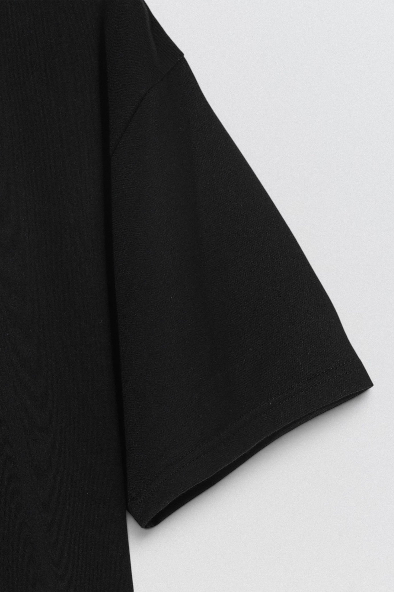 Undercover SS26 Give Bad People Good Ideas Black fabric on a white background