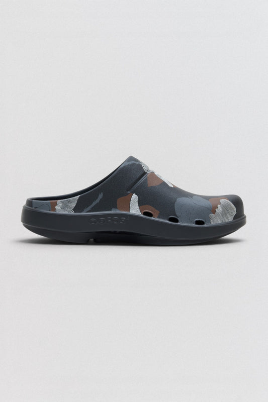 Undercover x OOFOS  Gray sandal with cartoon character design on a light gray background