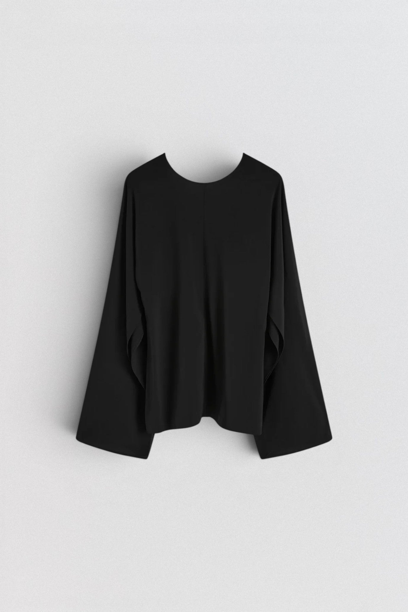 ST. AGNI Hybrid Top in black with multi-wear extended sleeves and fluid viscose construction
