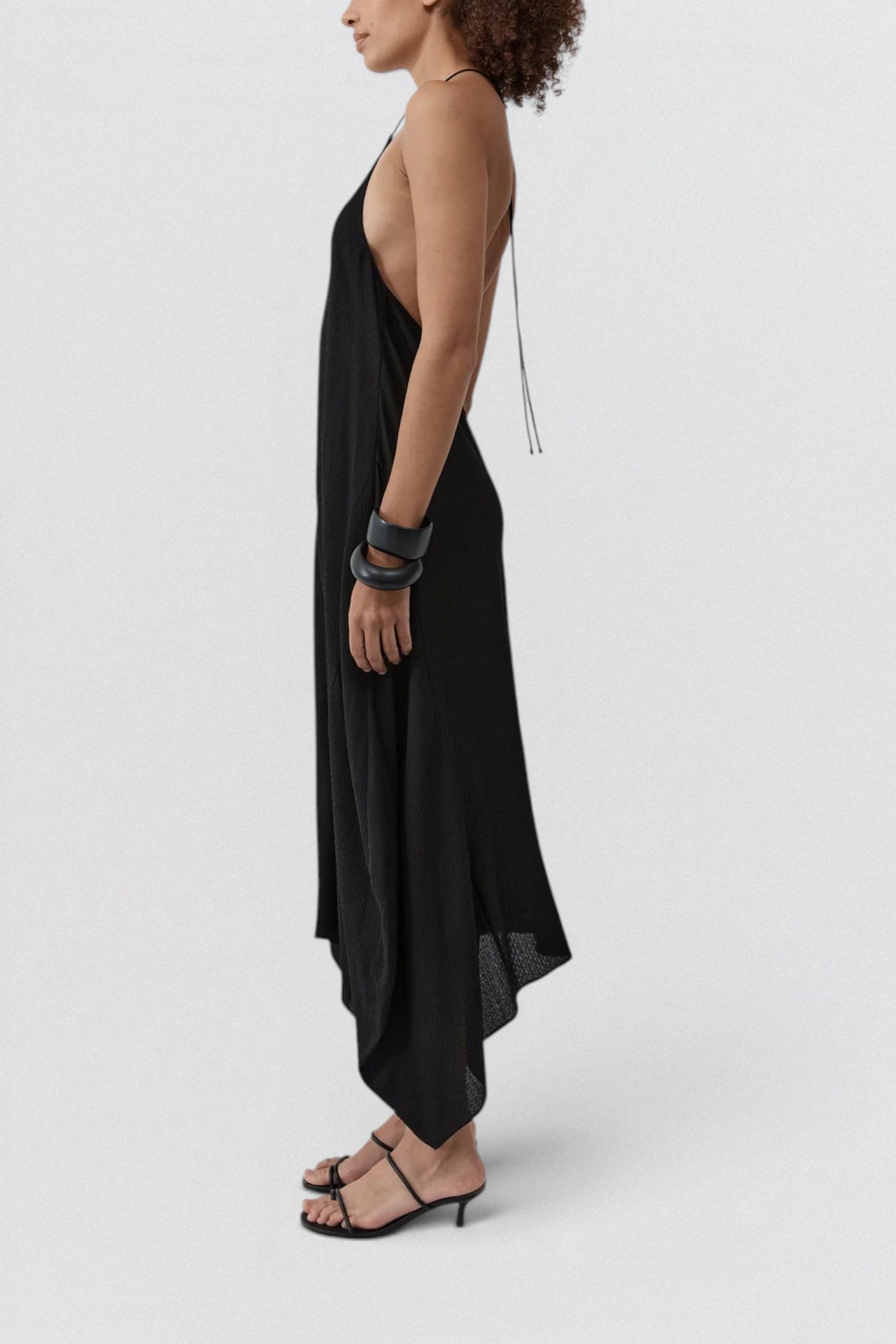 ST. AGNI Textured Weave Halter Dress in black with square halter neckline and asymmetric handkerchief hem