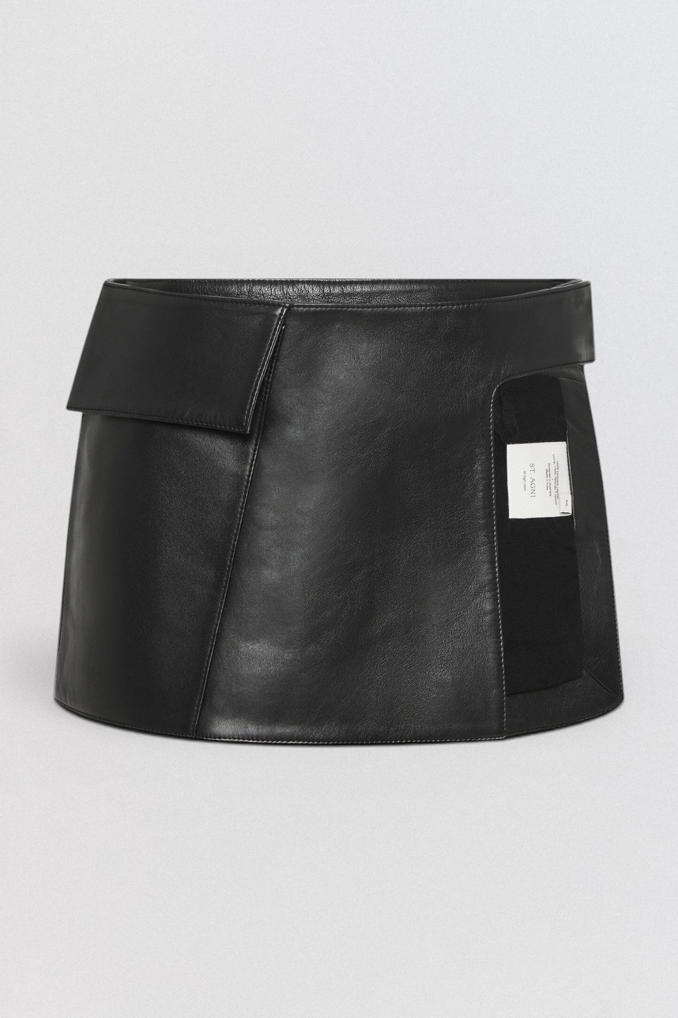 ST. AGNI Utility Skirt Belt in black lambskin leather with fold-over waistband and side cut-out detail