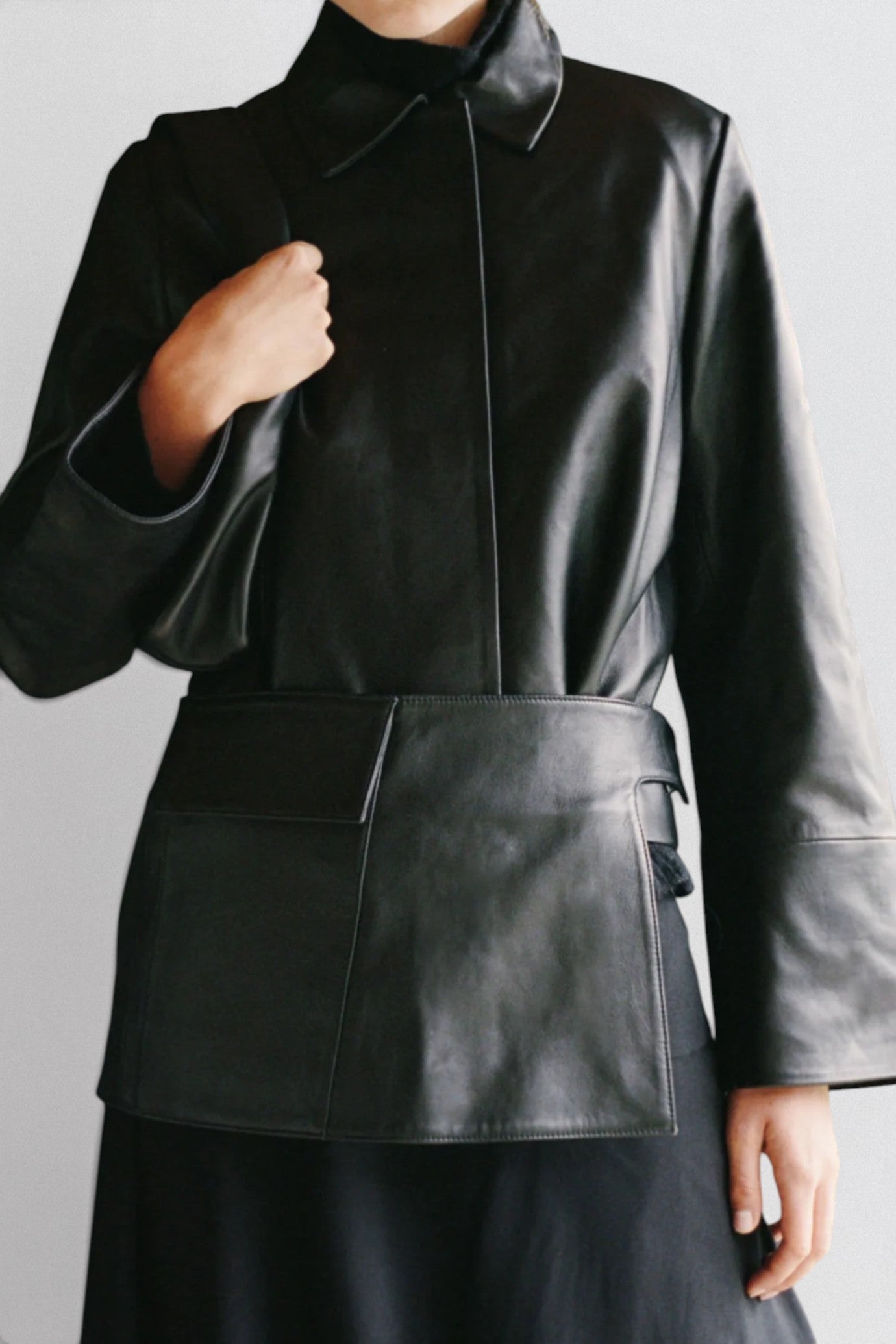 ST. AGNI Utility Skirt Belt in black lambskin leather with fold-over waistband and side cut-out detail